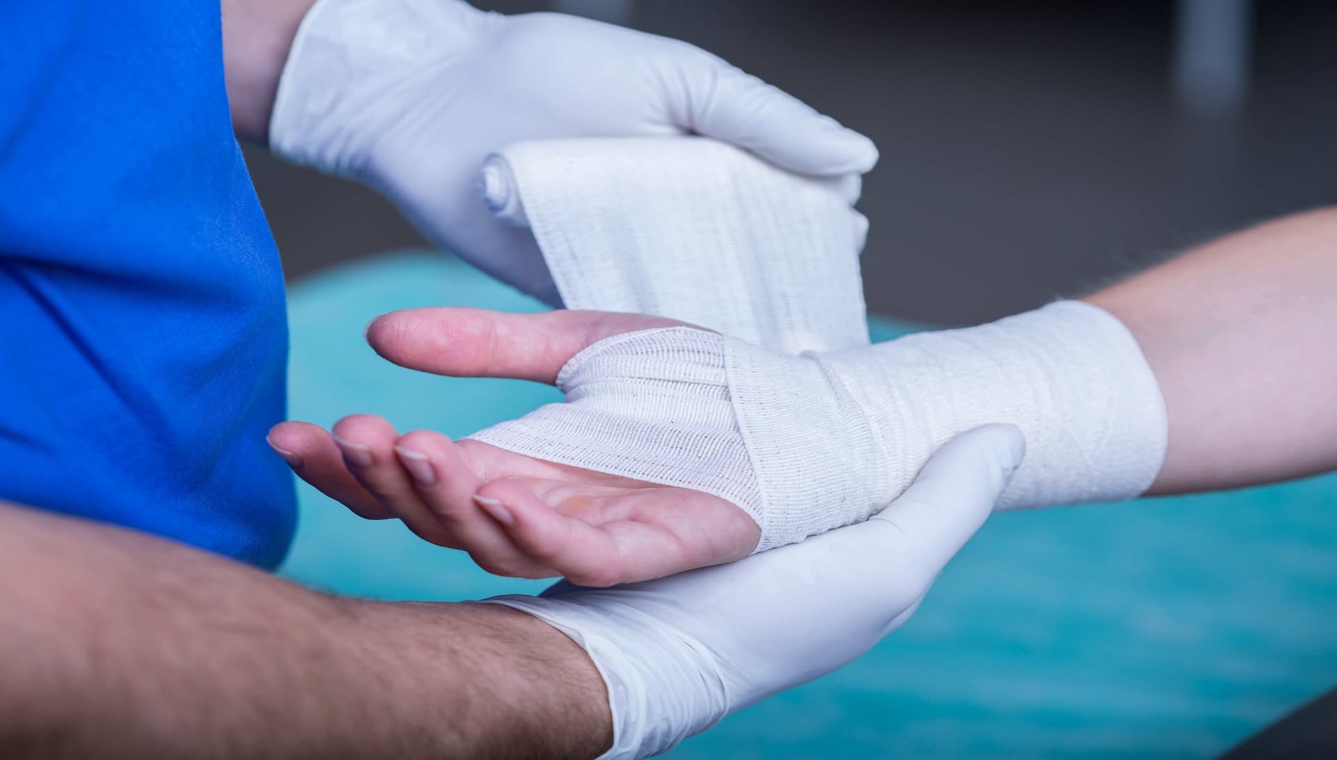 Medical professional carefully bandaging a patient's hand at Abilene Wound Care